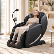 Woman relaxing in a Real Relax Favor-06 2026 black massage chair in a living room, front three-quarter view
